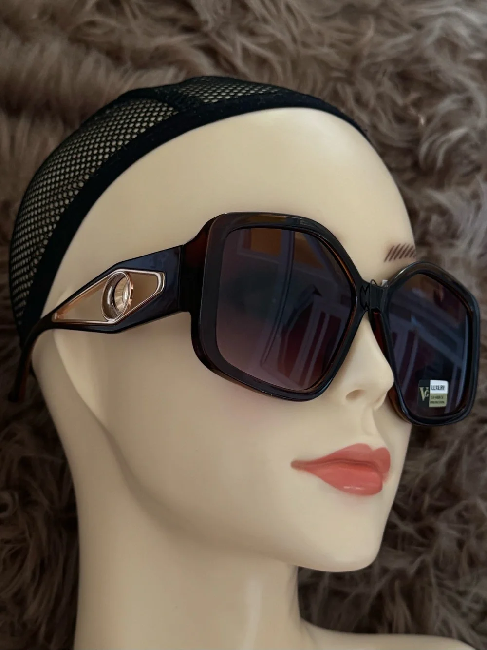 Futuristic sunglasses with large button detail on the sides